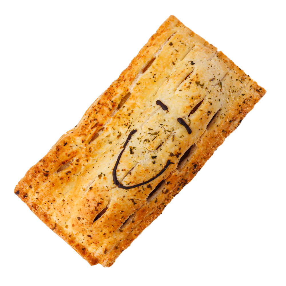 Pie Face Pork & Sage Kransky sausage roll, top view, featuring seasoned flaky pastry and a hand-drawn smiling face in dark icing